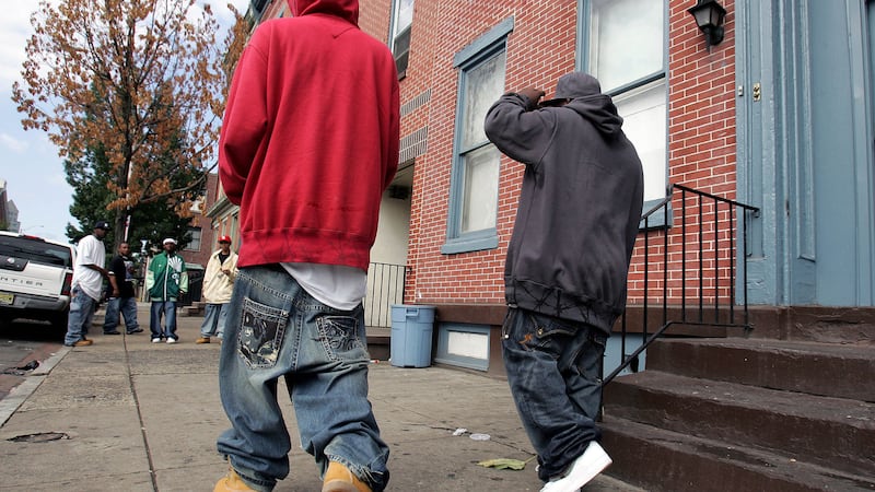 Two young men with low-slung, baggy jeans walk in Trenton, N.J., Saturday, Sept. 15, 2007.