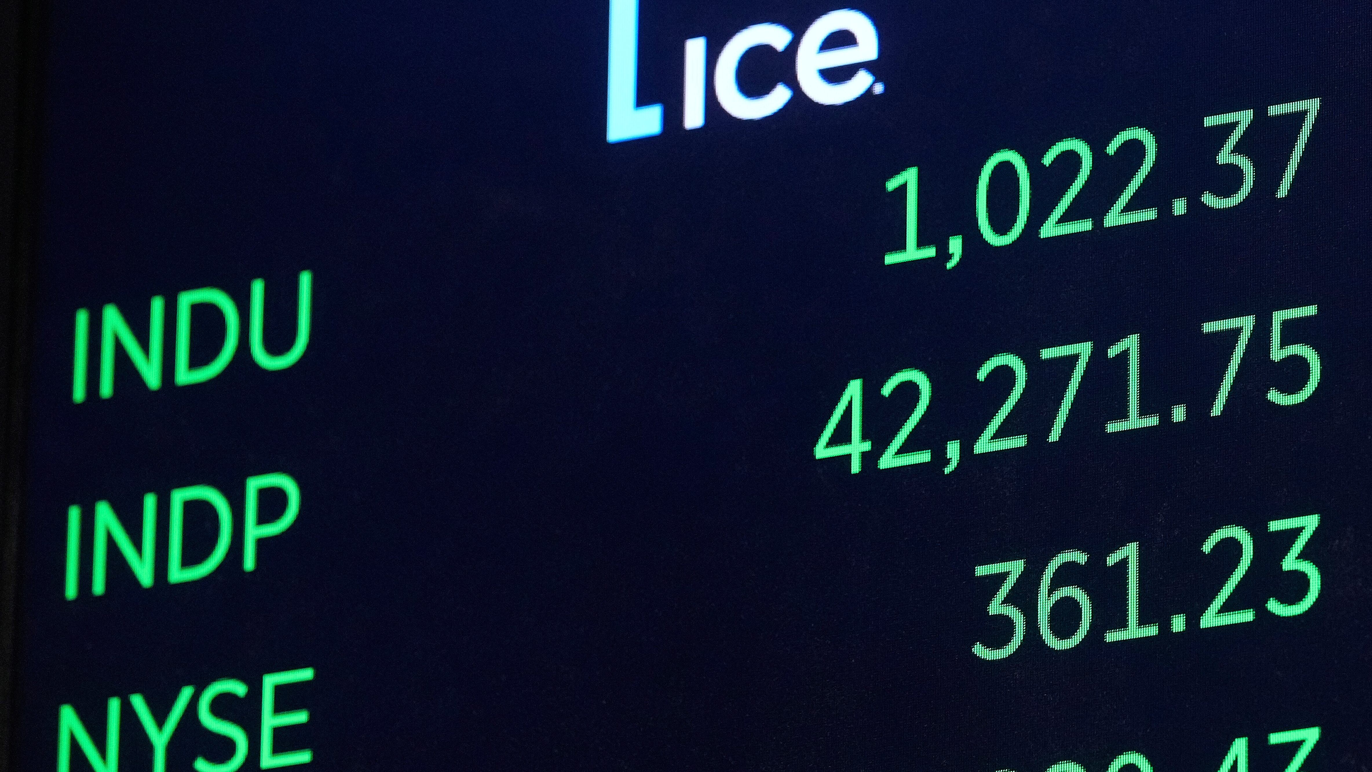 The Dow Jones industrial average, top, opens higher at the New York Stock Exchange, Monday,...