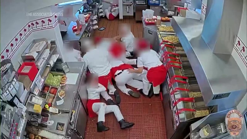 Video shows a gunman at an In-N-Out Burger killing one of his victims through a drive-up...
